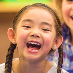 girl in pig tails smiling