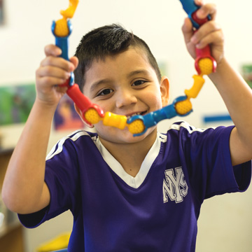 boy holding up toy