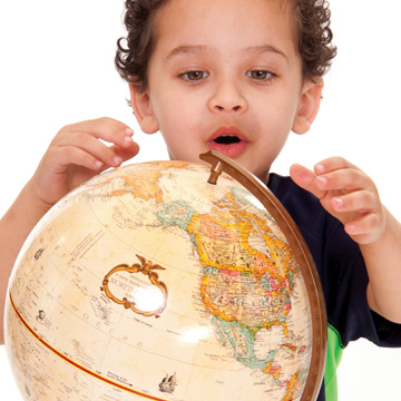 boy looking at globe